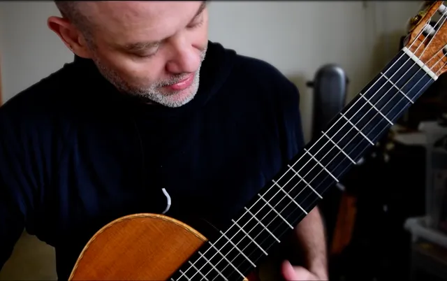 Rhayn Jooste looking down at the fretboard while playing